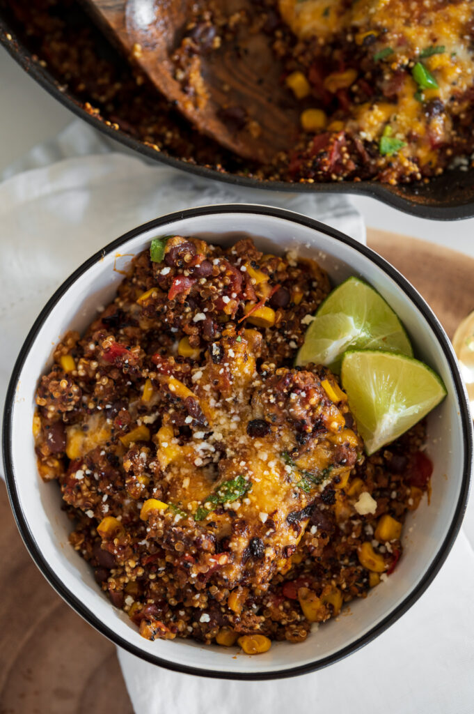 ground beef and quinoa in a bowl with lime wedges