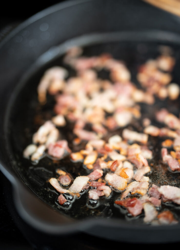cooking bacon in an enameled cast iron skillet