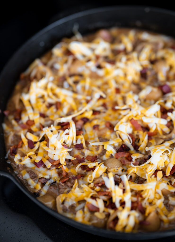 shredded cheese on top of finished bacon cheeseburger ground beef pasta