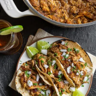 Dutch oven shredded chicken tacos served with a cerveza