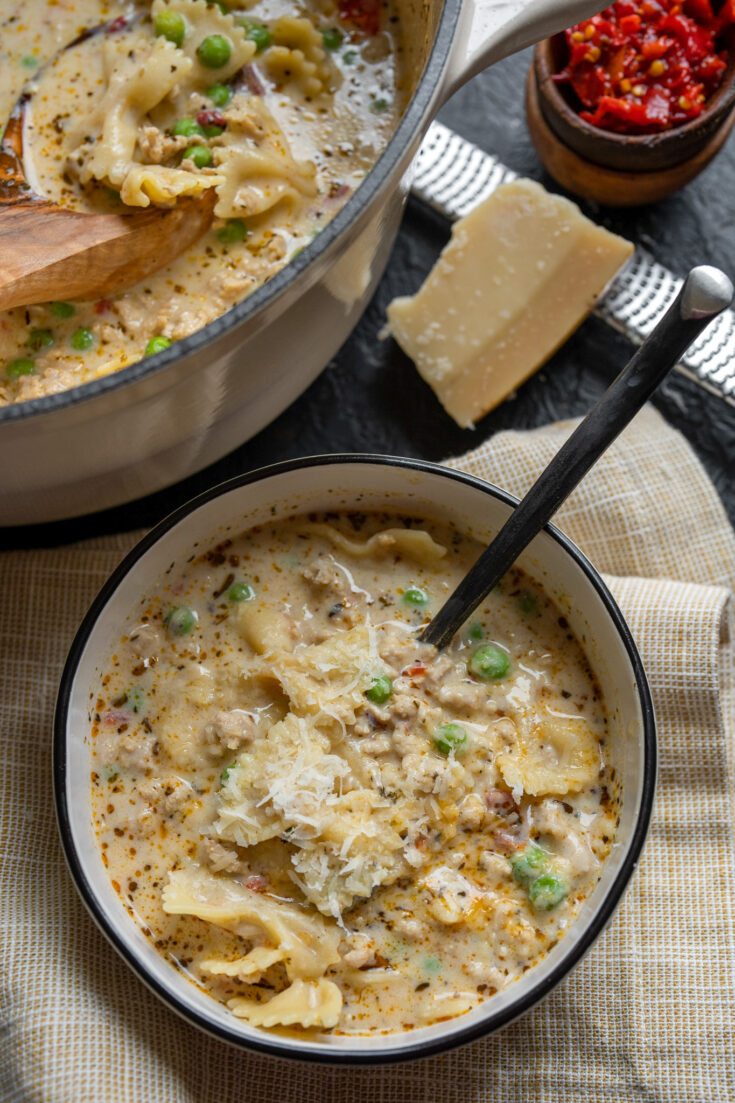 bowl of Italian ground chicken soup topped with grated parmigiano reggiano